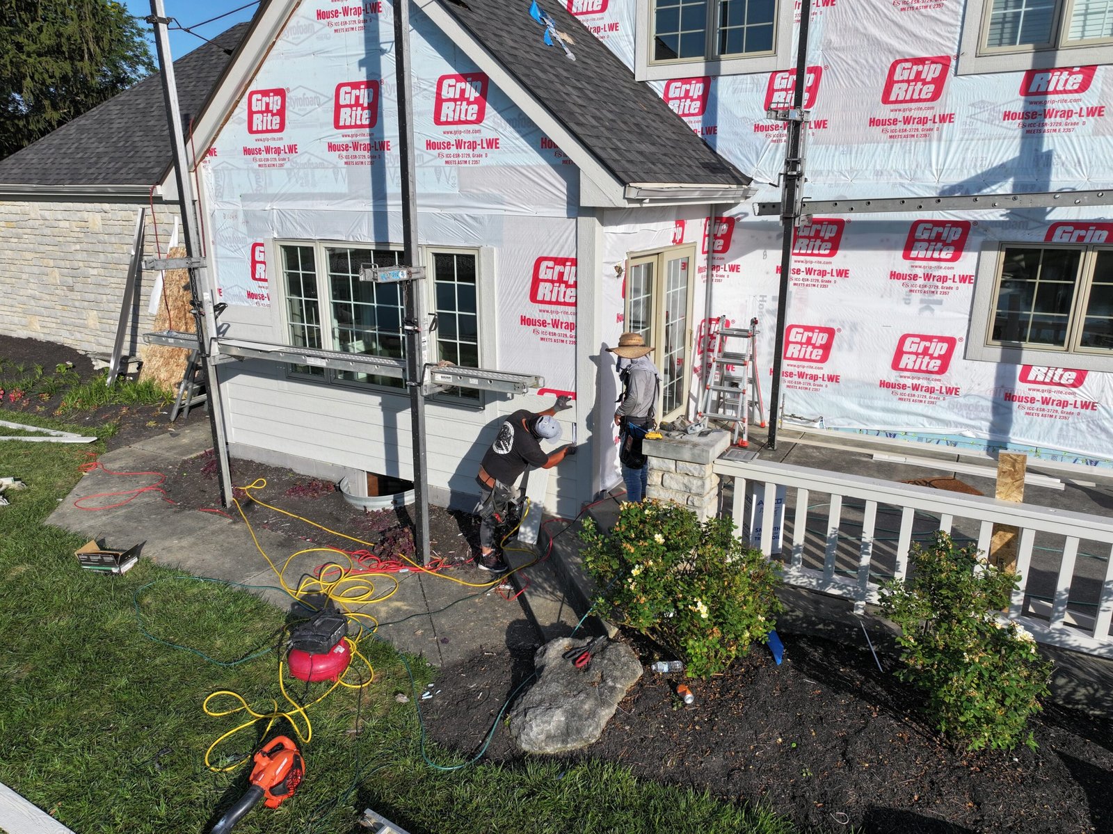 Assured Restoration installers completing a full siding project