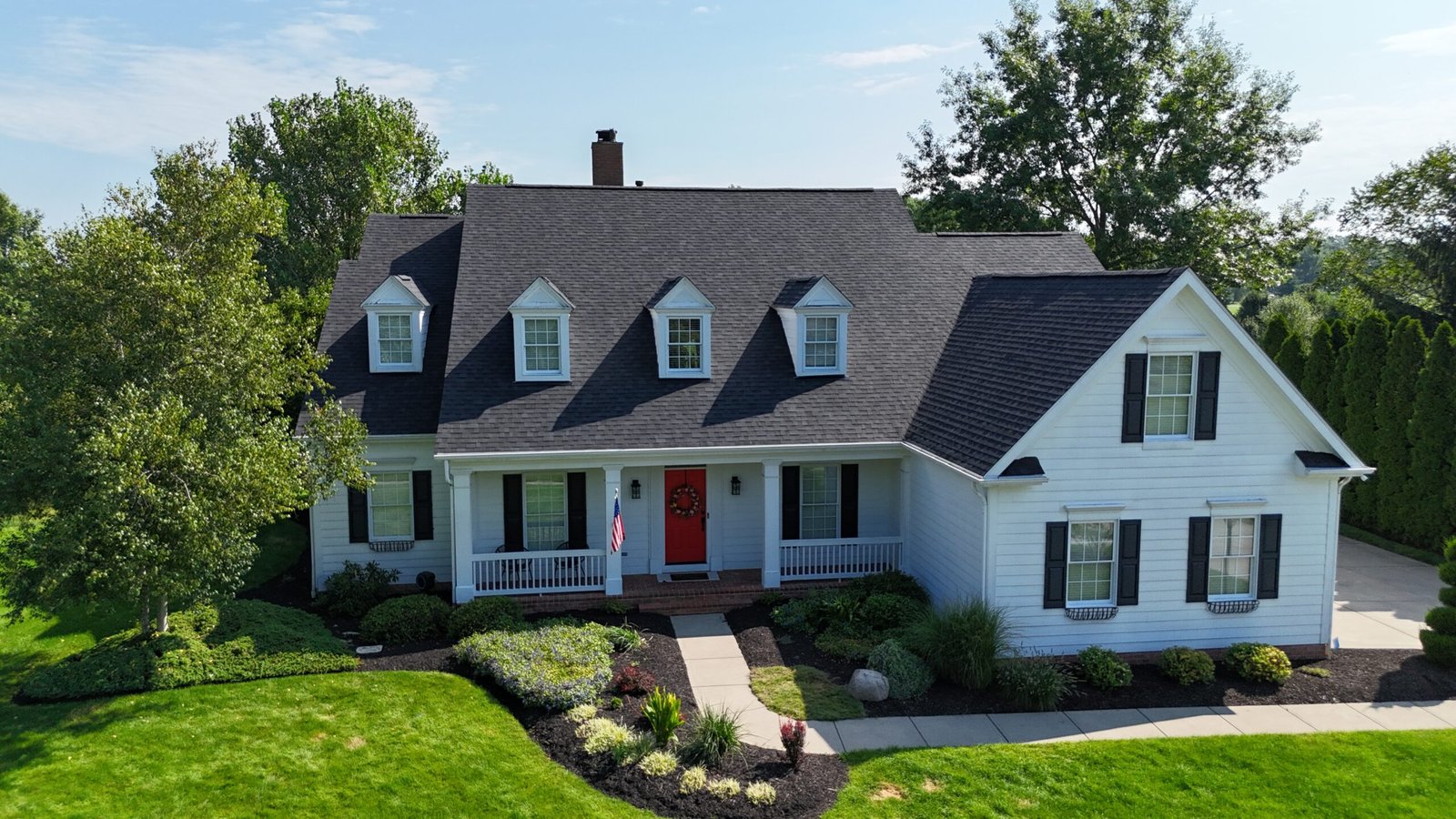 Completed roof replacement on a white home